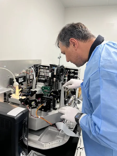 ScientifiCo technician repairing laboratory equipment